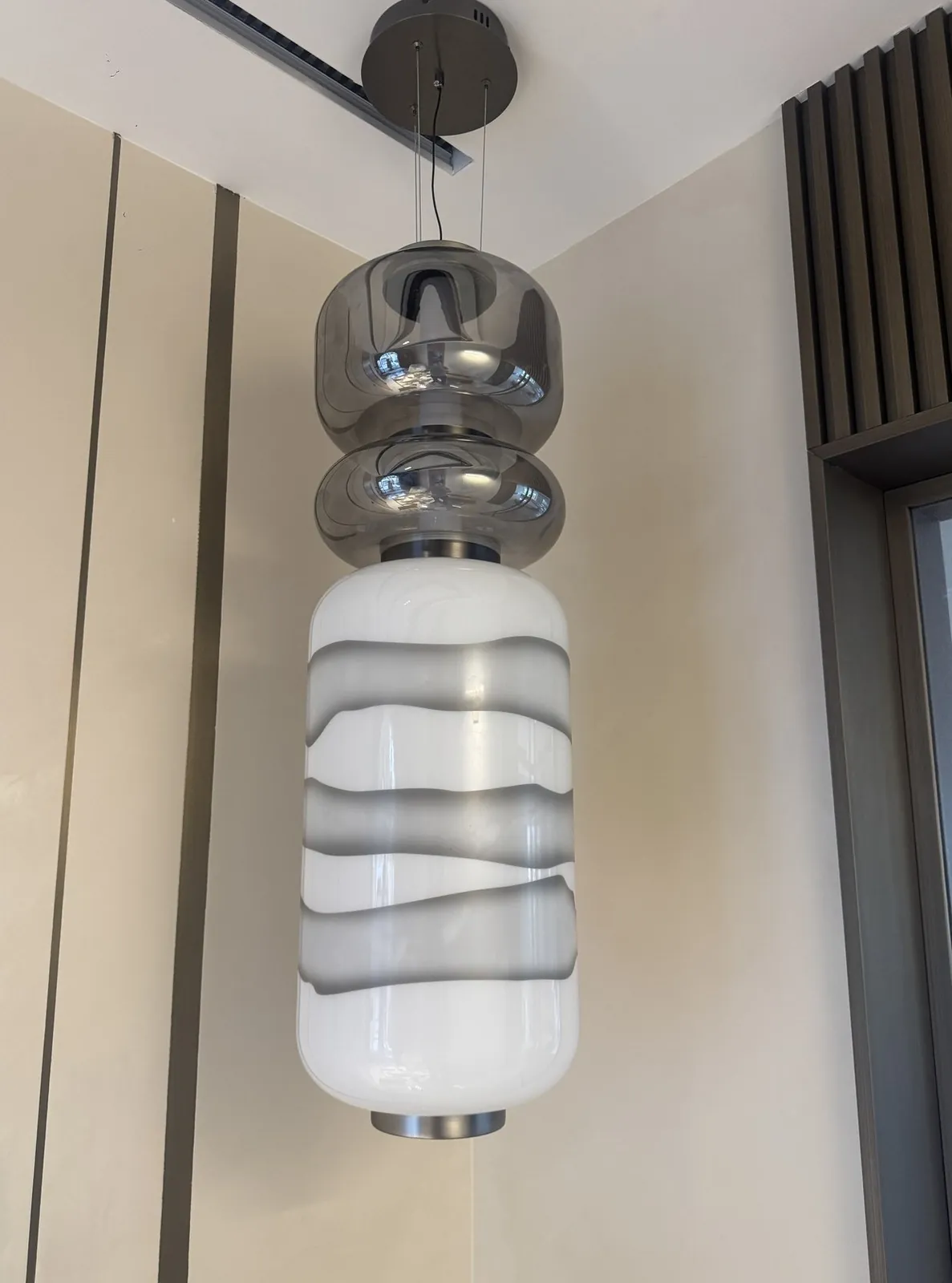 Decorative pendant during installation in a separate anonymized interior project.