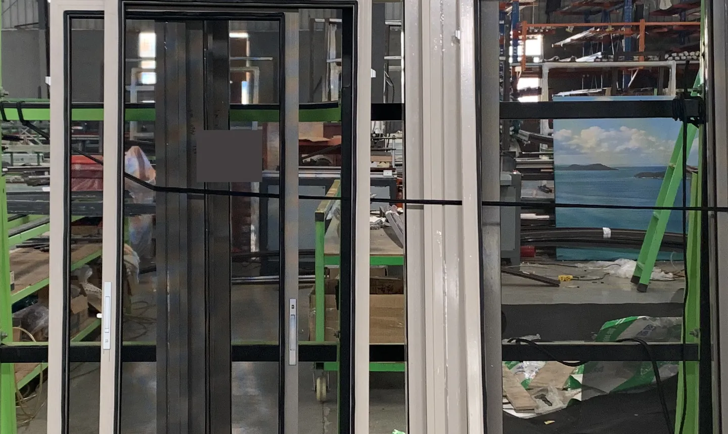 Anonymized window units staged on a factory rack for visual quality review.